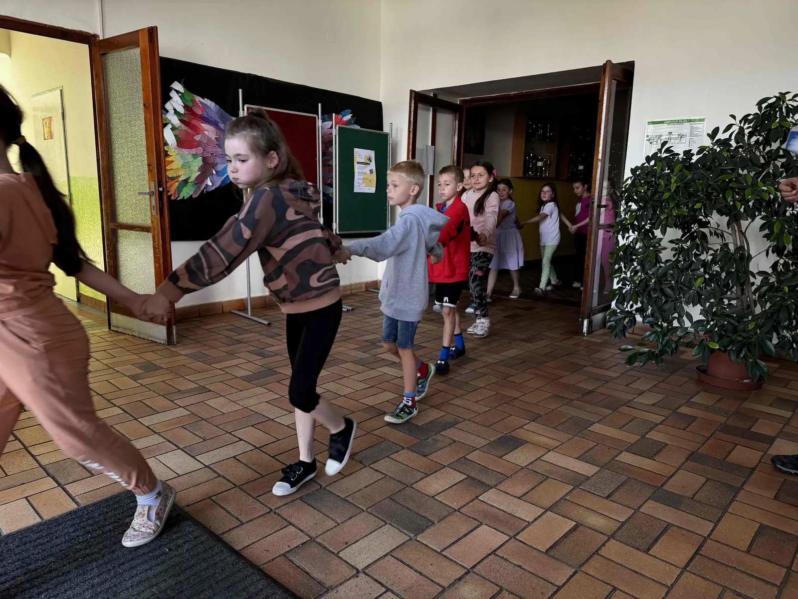 Children being evacuated from the school building, holding hands
